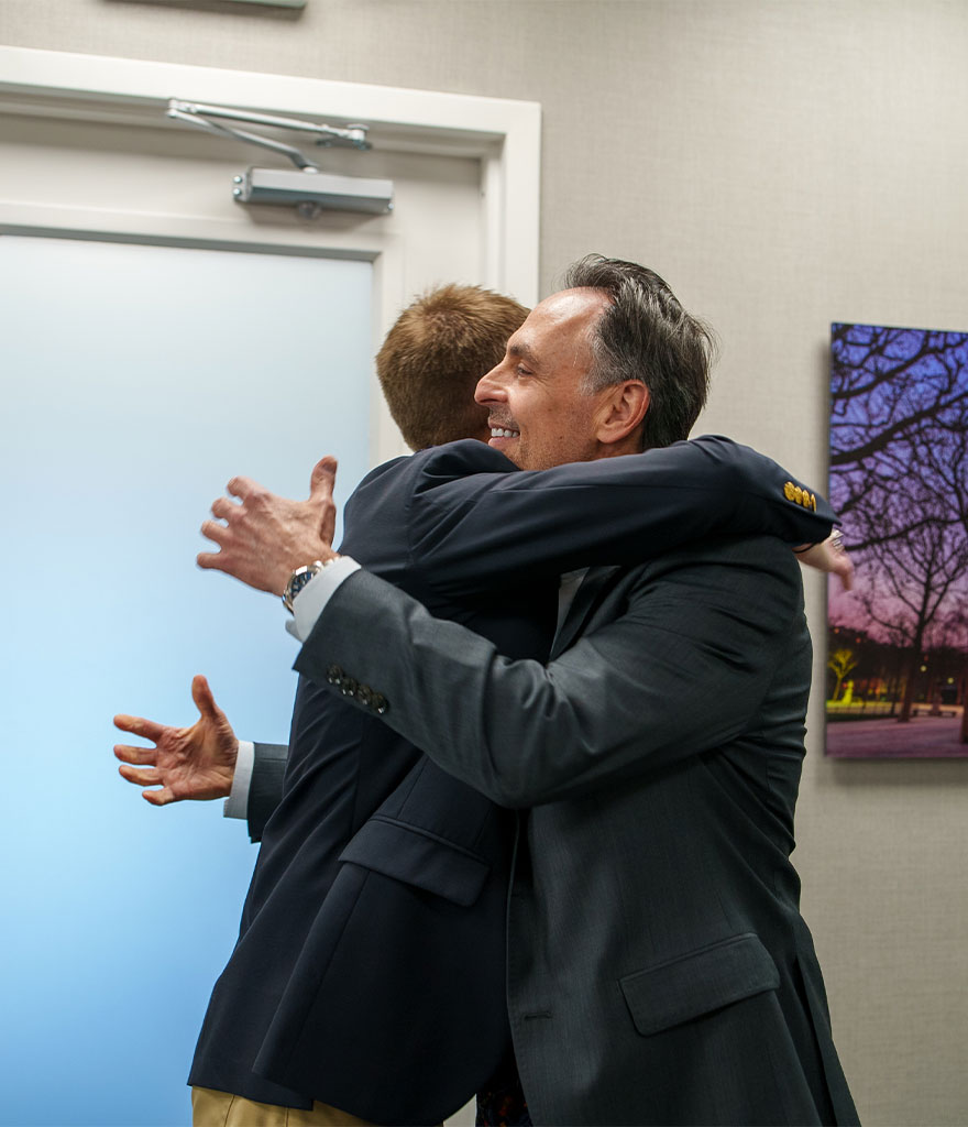 Patient hugging doctor