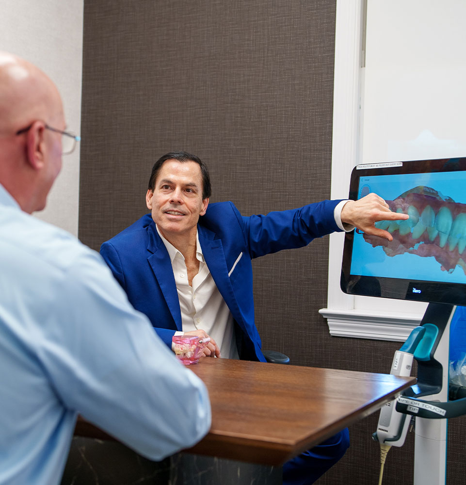 Doctor Pointing at 3d scan of Patients teeth