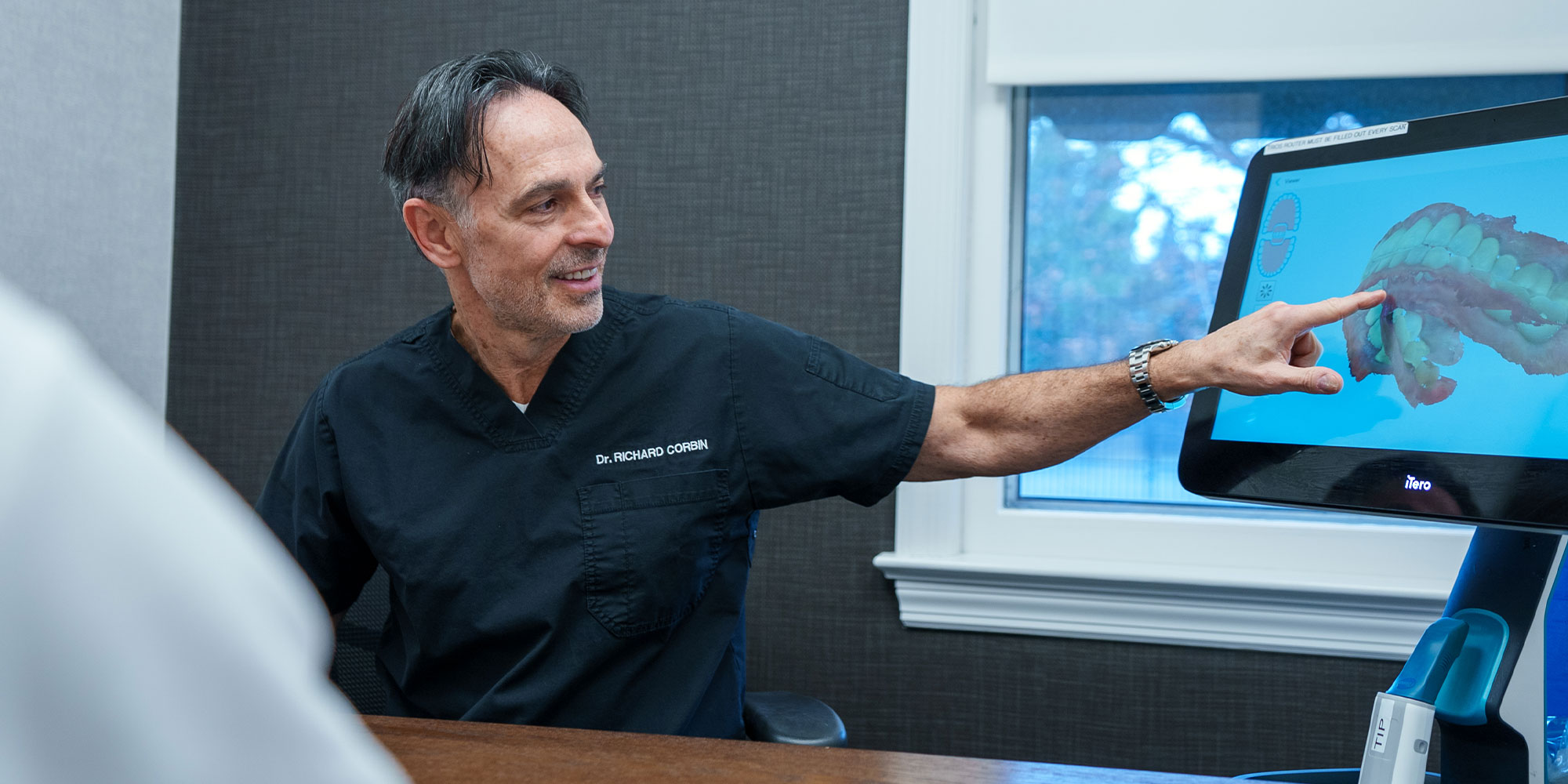 Doctor pointing at 3d scan of Patients Teeth