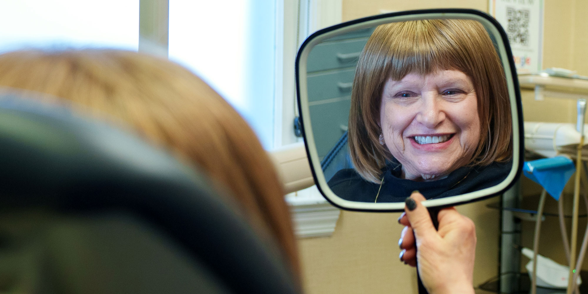 Patient Smiling into Mirror