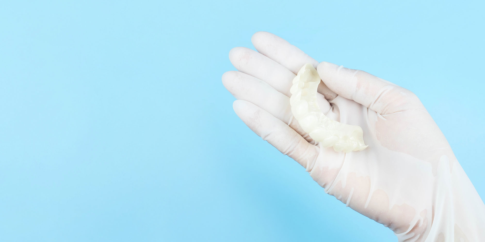 snap on denture model in hand hero